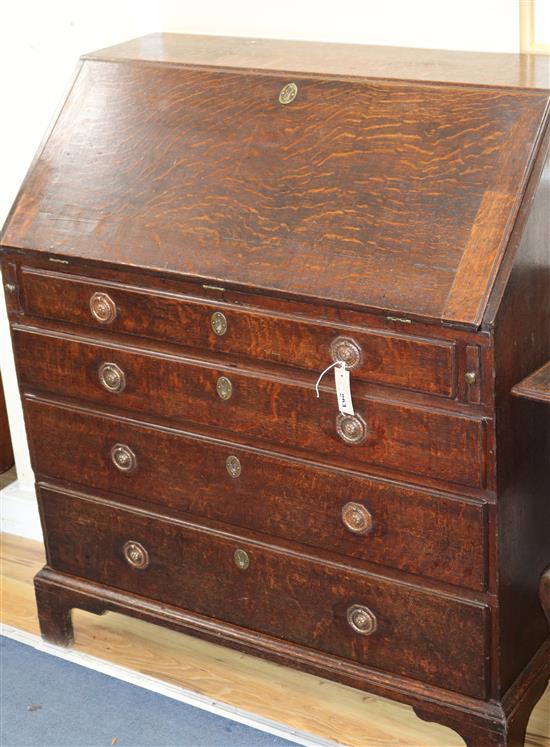 A George III oak bureau, with later handles W.94cm